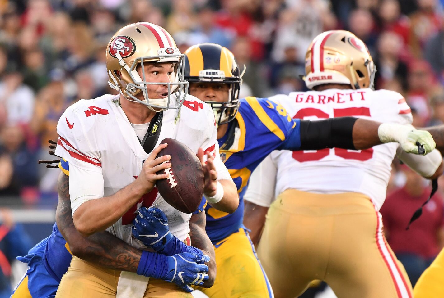 49ers quarterback Nick Mullens is sacked by Rams linebacker Mark Barron.
