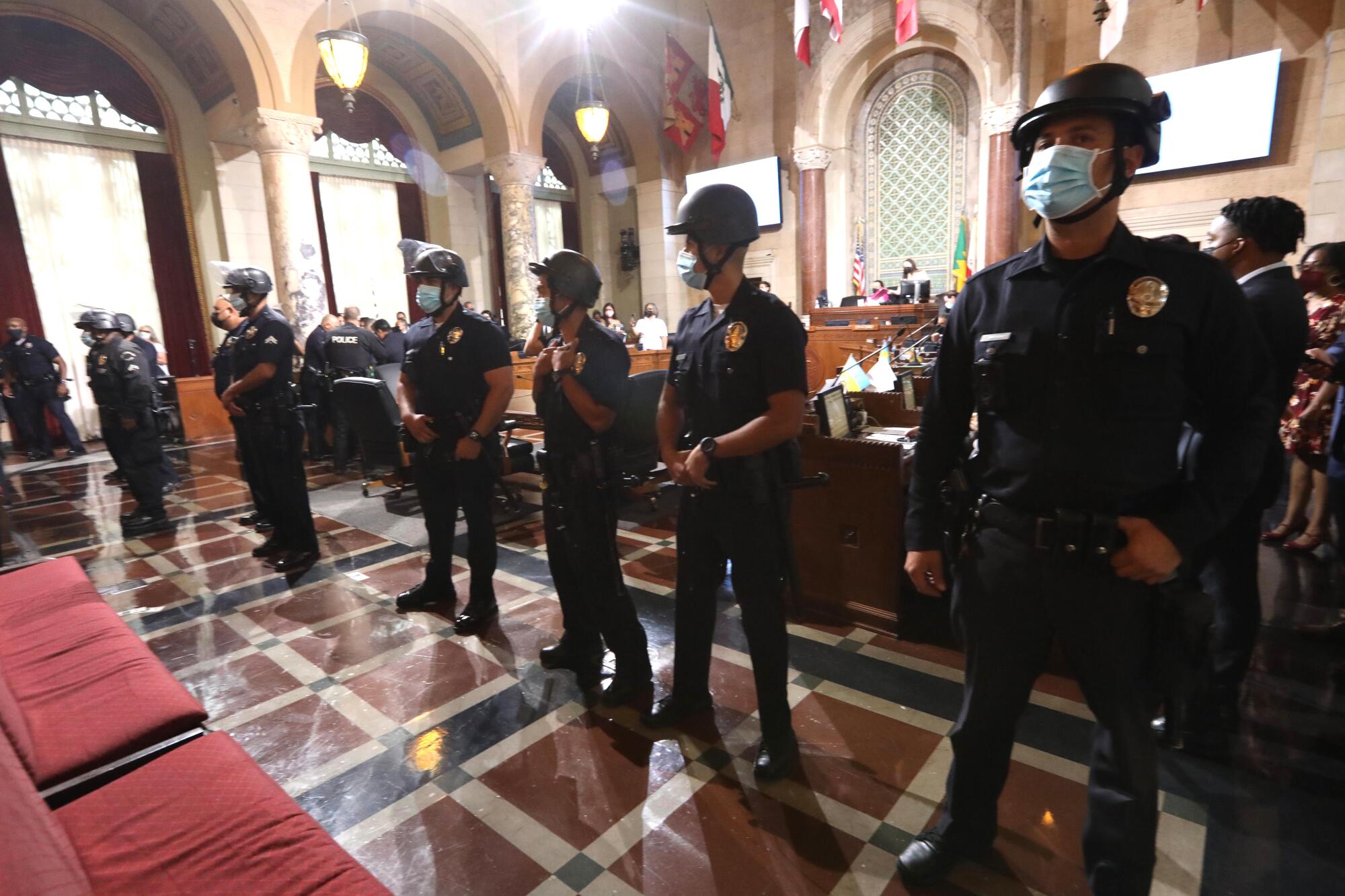LAPD officers stand guard after a homeless advocate tried to rush City Council members at City Hall.