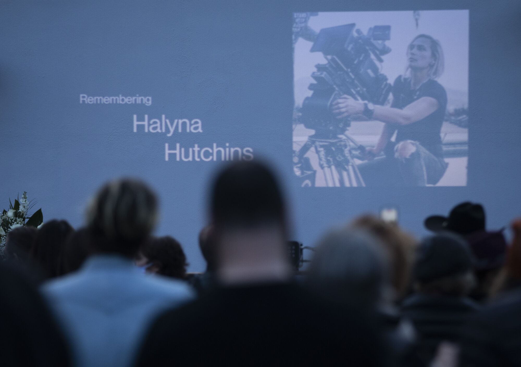 An image of cinematographer Halyna Hutchins is shown at a candlelight vigil Sunday.