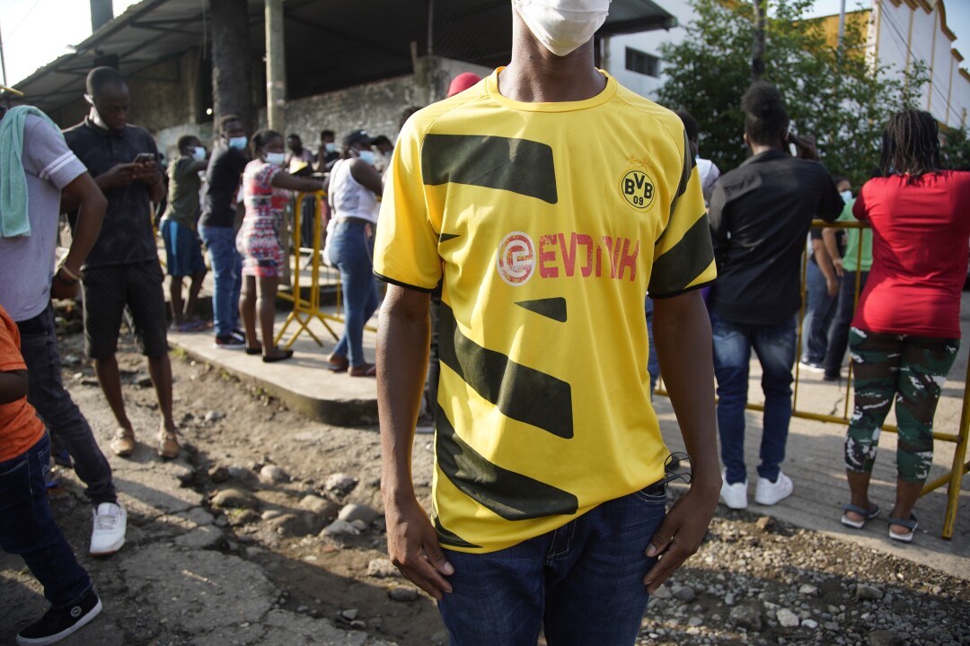 Johny stands near an asylum office in Tapachula