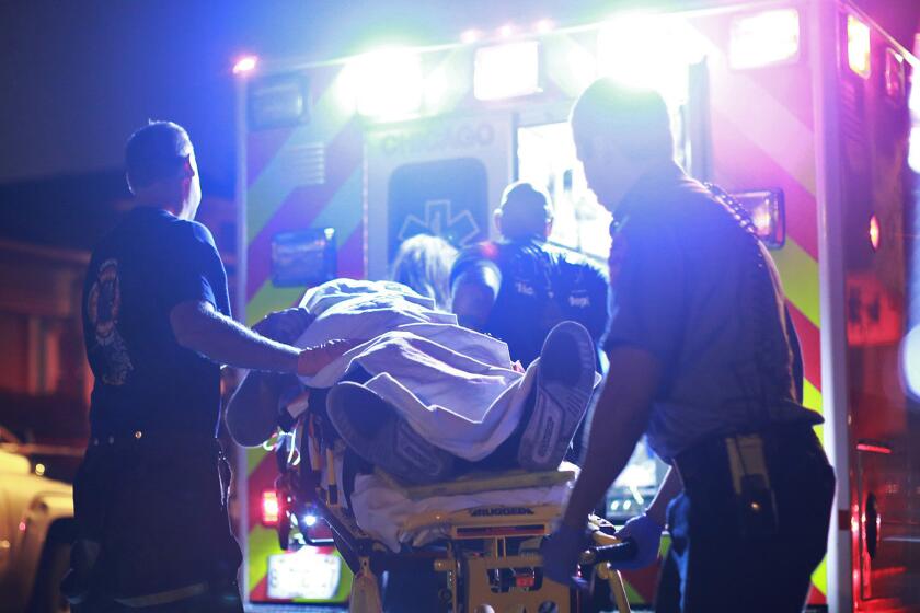 Paramedics in Chicago transport a 20-year-old victim from the scene of a shooting in August.