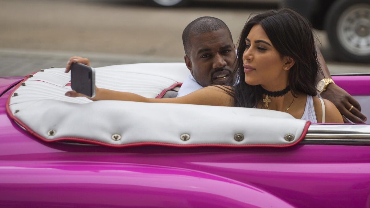 Kim Kardashian takes a selfie while riding with Kanye West in a classic car in Havana, Cuba, on May 5.