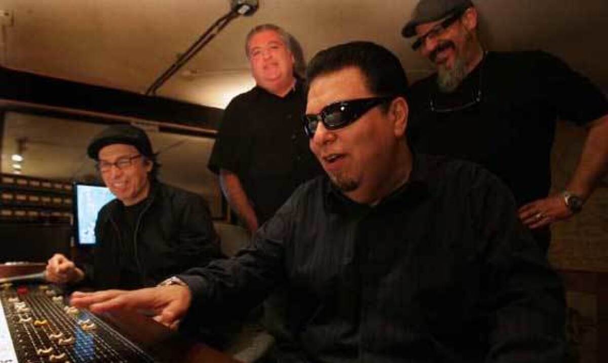 Louie Perez, from left, David Hidalgo, Cesar Rosas and Steve Berlin of the East Los Angeles band work in a music studio.
