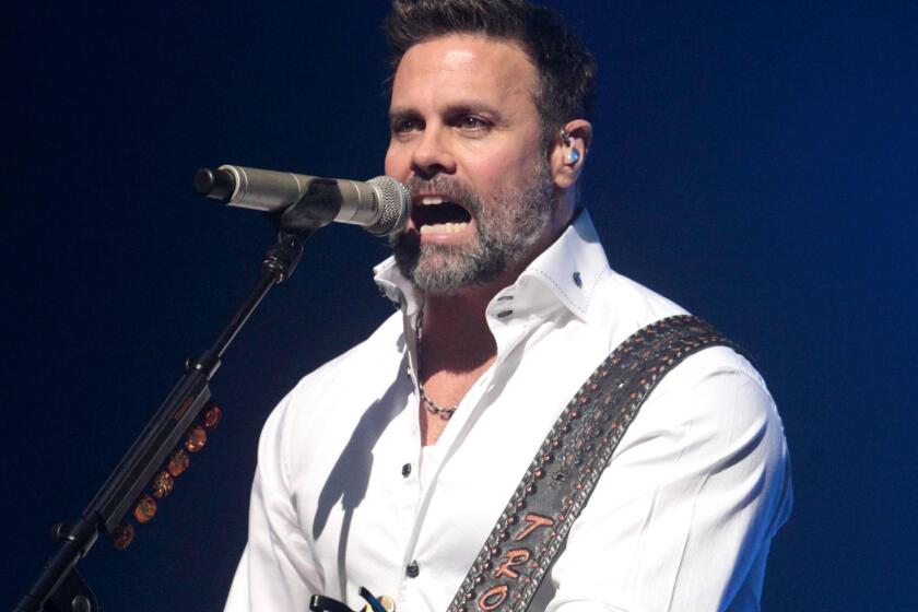 FILE - In this Jan. 17, 2013 file photo, Troy Gentry of the Country Music duo Montgomery Gentry performs on the Rebels On The Run Tour in Lancaster, Pa. Gentry, one half of the award-winning country music duo Montgomery Gentry, died Friday, Sept. 8, 2017, in a helicopter crash, according to a statement from the bandâs website. He was 50. The group was supposed to perform Friday at the Flying W Airport & Resort in Medford, N.J. (Photo by Owen Sweeney/Invision/AP, File)