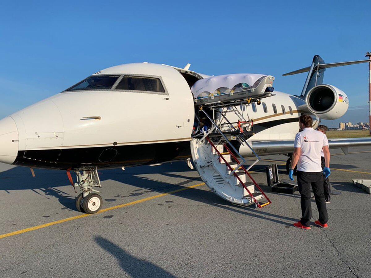 Medics upload Alexei Navalny into a German special medical plane at an airport in Omsk, Russia. 