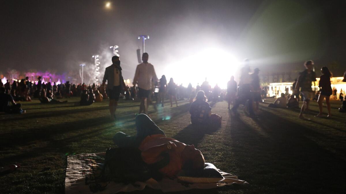 A man naps while Beyoncé performs off in the distance.