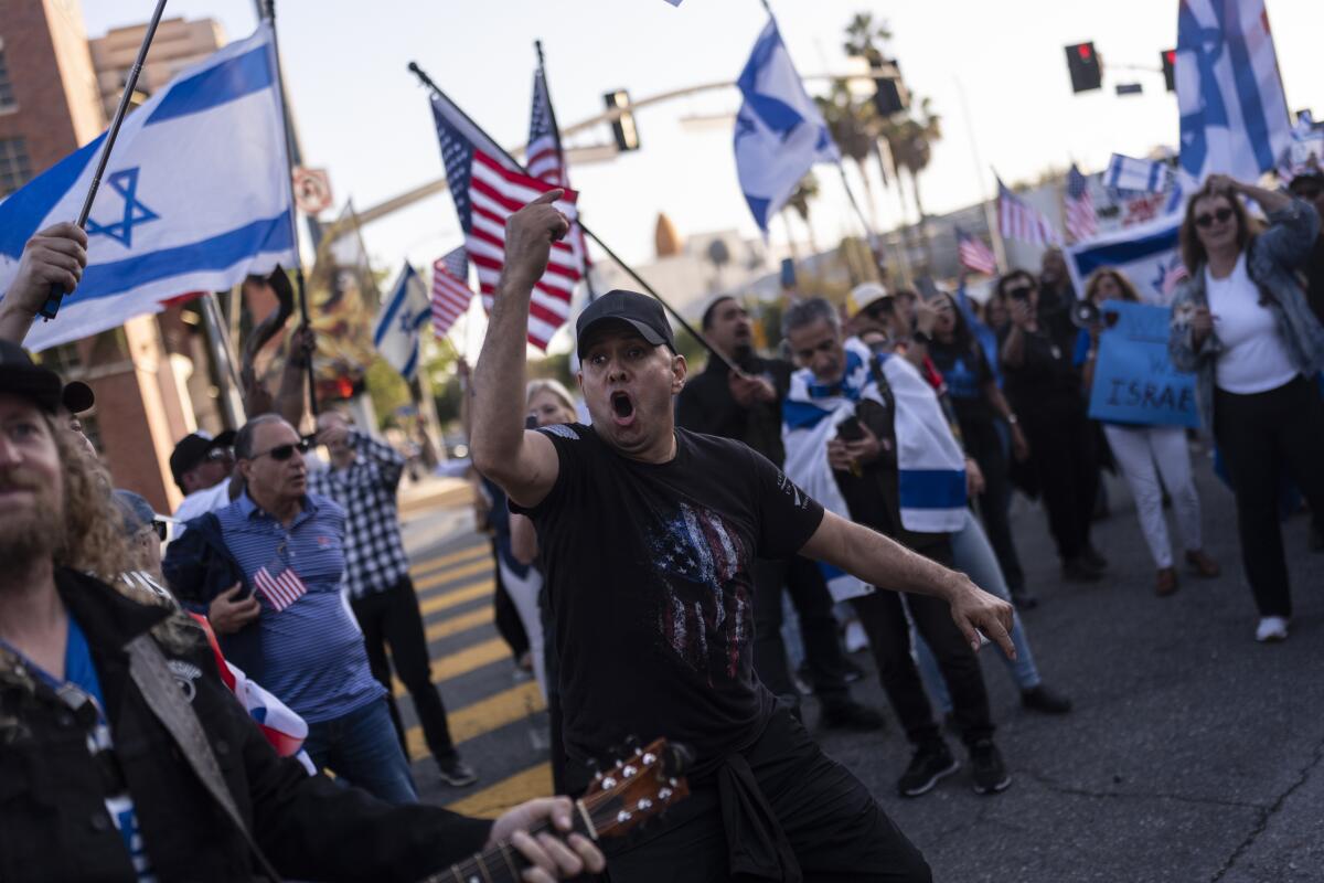 Demonstrators wave Israeli and American flags