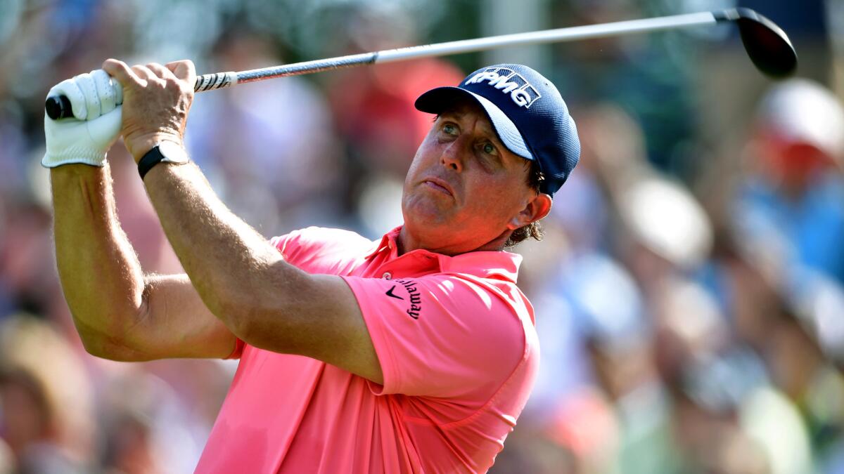 Phil Mickelson follows through on his tee shot at No. 13 on Thursday during the first round of the PGA Championship.