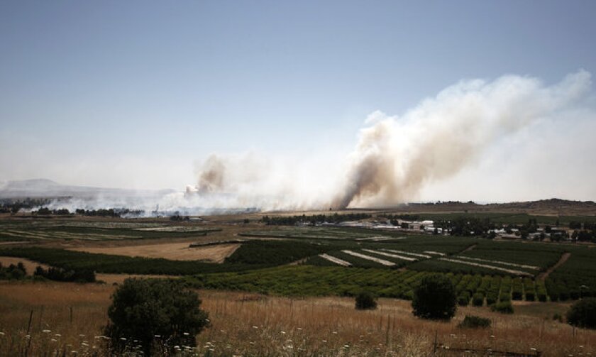 A picture taken from the Israeli side of the cease-fire line with Syria shows smoke billowing during clashes between Syrian rebels and forces loyal to the government.