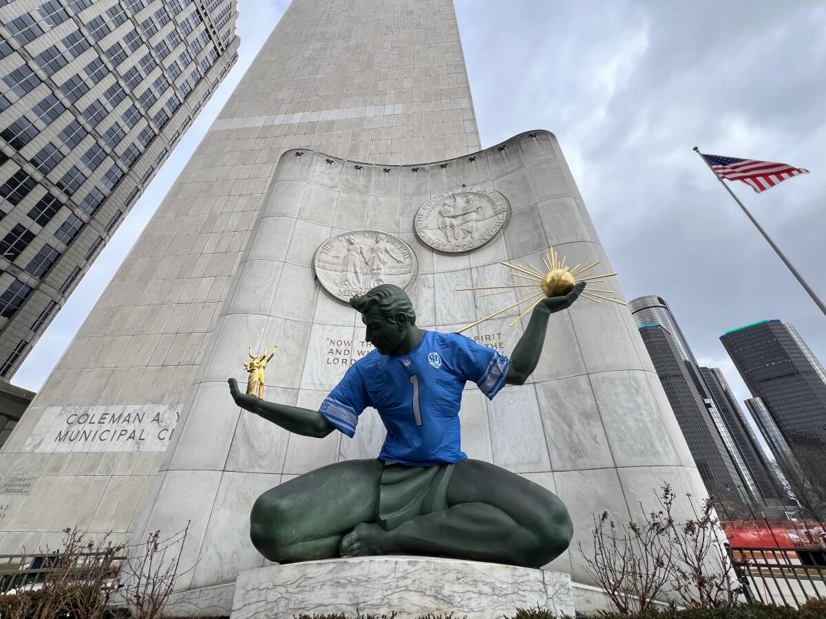 The Spirit of Detroit, a sculpture at the beginning of Woodward Avenue, is adorned with a Lions jersey. 