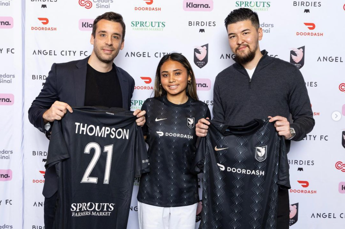 A&V Sports Group founder Alan Naigeon, left, stands next to Alyssa Thompson and her agent, Takumi Jeannin.
