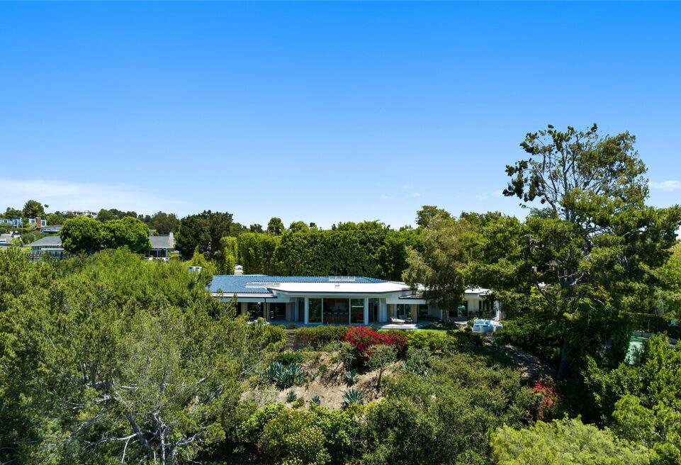 Built in 1971, the home still boasts Midcentury charm with sharp angles, long hallways and loads of wood and glass.