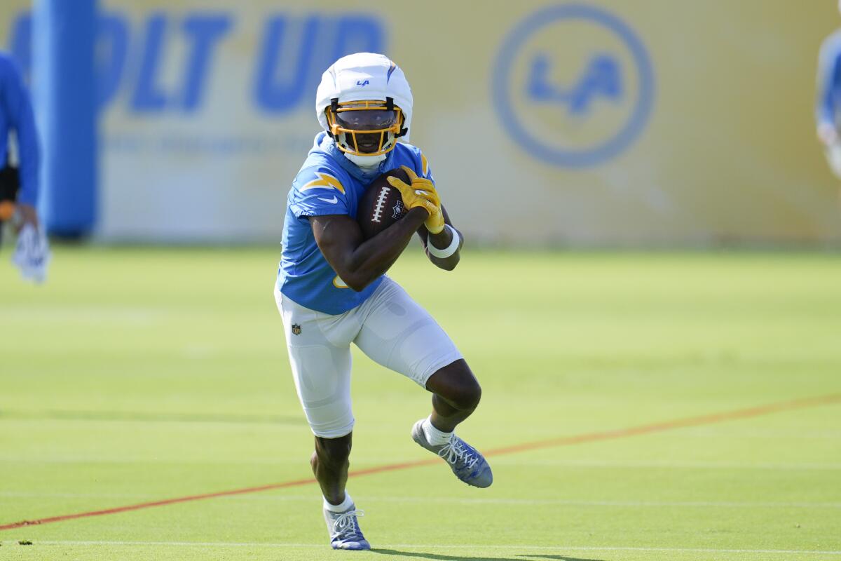  Chargers receiver Joshua Palmer (5) runs after a catch during training camp in El Segundo.