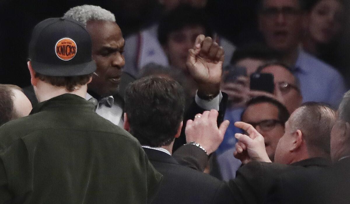 Former New York Knicks player Charles Oakley exchanges words with a security guard during the first quarter of the Knicks-Clippers game Wednesday.