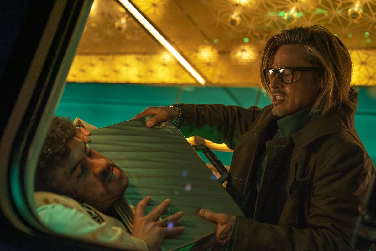 This image released by Sony Pictures shows Bad Bunny, left, and Brad Pitt in a scene from "Bullet Train." (Scott Garfield/Sony Pictures via AP)