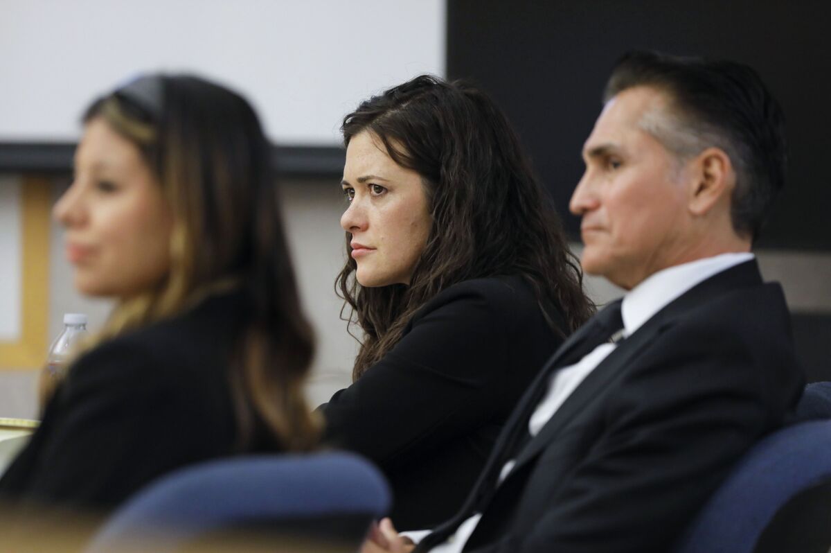 Jade Janks, center, listens to opening statements at the Vista courthouse Dec. 7, 2022
