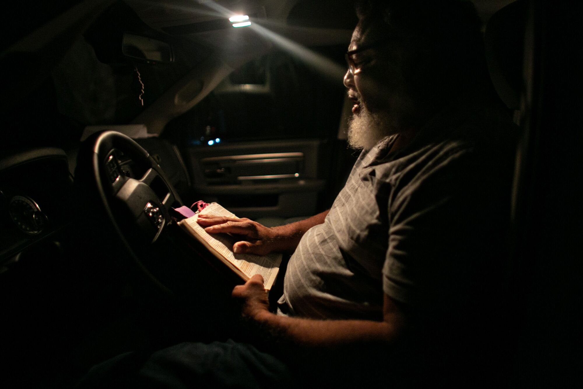 Pastor Albert Mann of Gordon Chapel Community Church starts his Sundays by praying and reading the Bible in his truck.