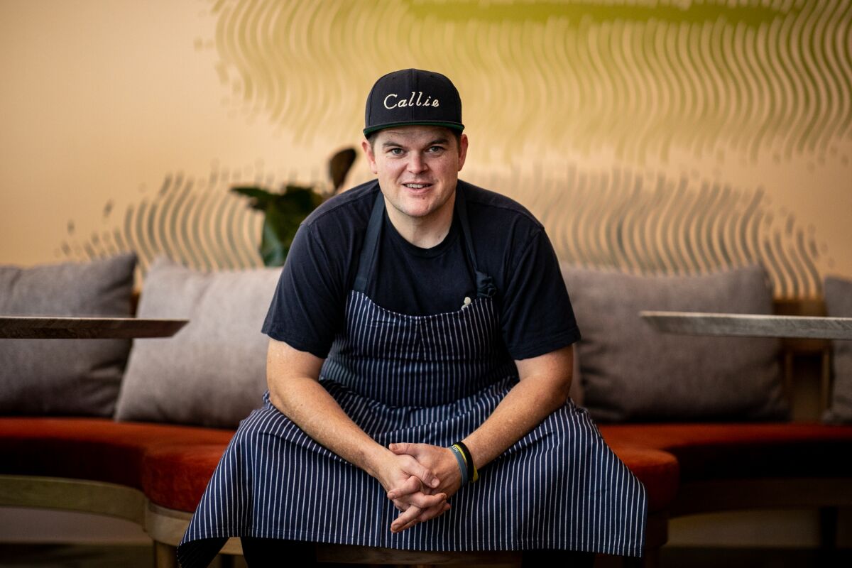 Chef Travis Swikard poses in his long-awaited East Village restaurant Callie, which opened in June 2021.