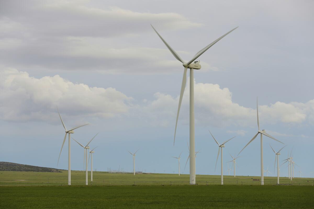 Wind turbines stand at a wind farm along the Montana-Wyoming state line