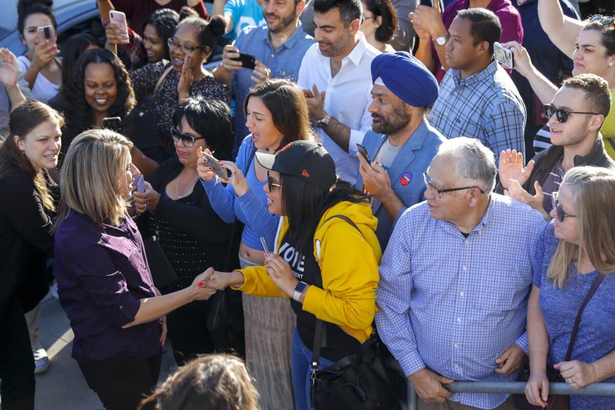 Then-candidate Katie Hill greets supporters as she arrives at the Newhall Family Theatre, in Santa Clarita. On Nov. 1, Hill stepped down from her congressional seat after the release of her nude photos.