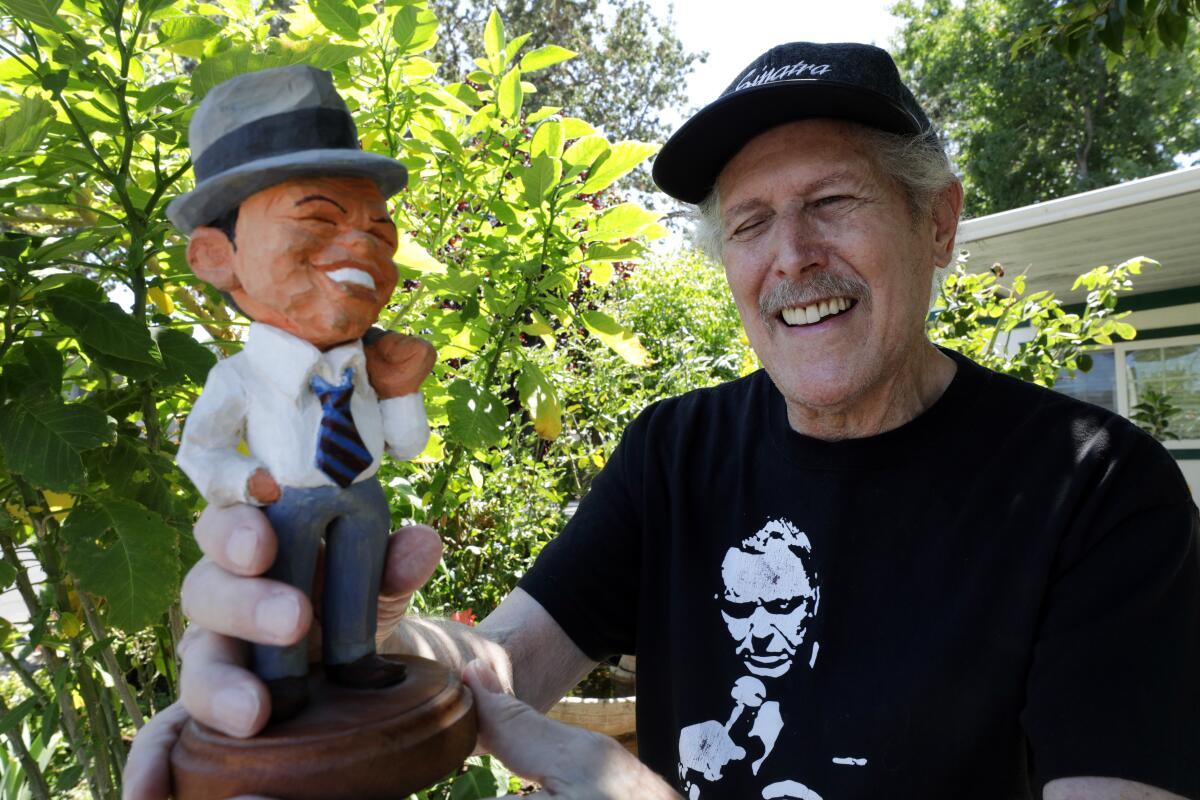 Frank Sinatra archivist Ric Ross holds a custom-made sculpture of the Chairman of the Board.