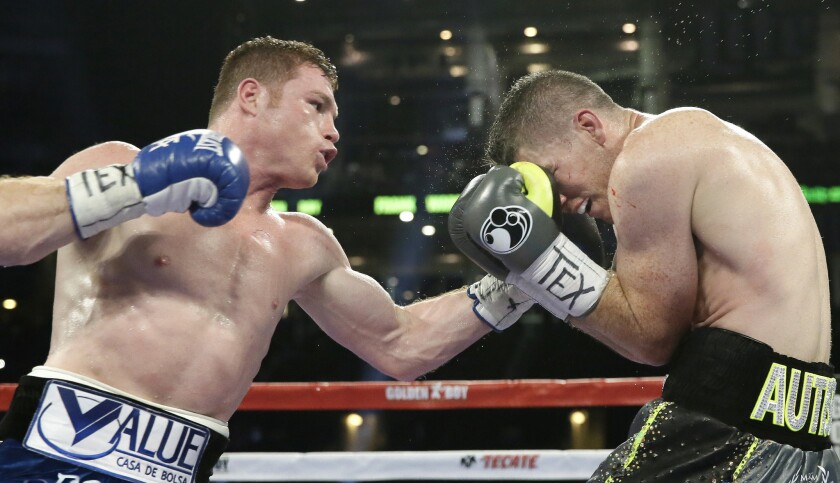 Canelo Alvarez goes on the offensive against Liam Smith during the WBO junior-middleweight title fight.