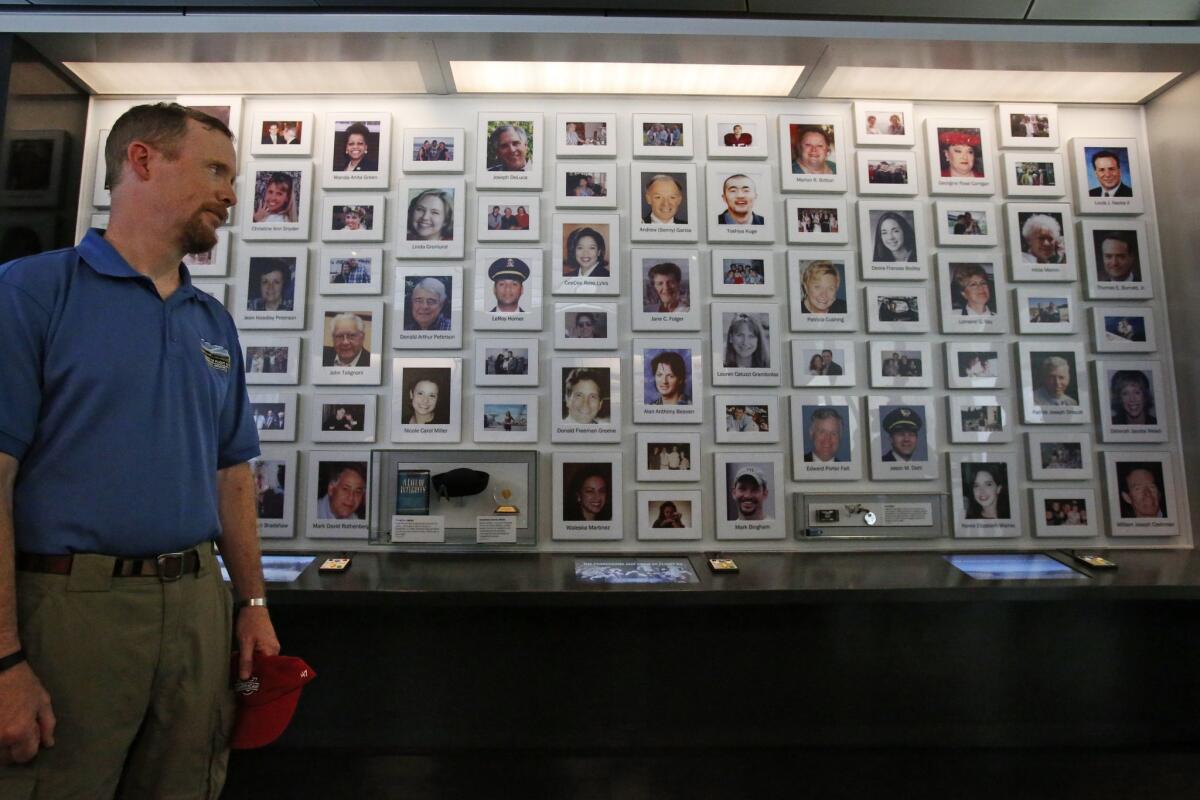 Gordon Felt, whose brother Edward Felt was killed on United Airlines Flight 93, stands in front of a wall of photos of the 40 crew members and passengers who perished in the crash. The photos are part of a display at the new Flight 93 National Memorial Visitor Center.
