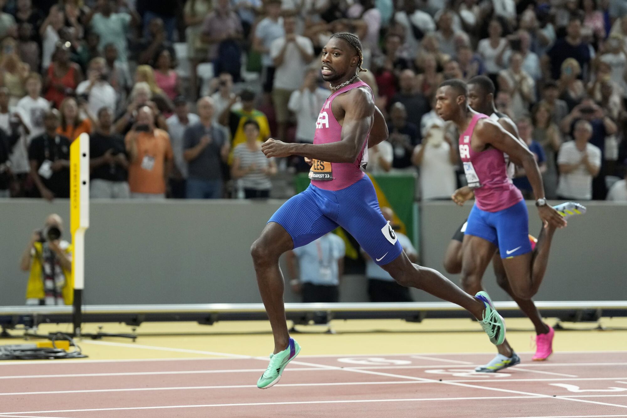 Noah Lyles crosses the finish line to win the gold medal in the 200 meters at the world track championships on Friday.