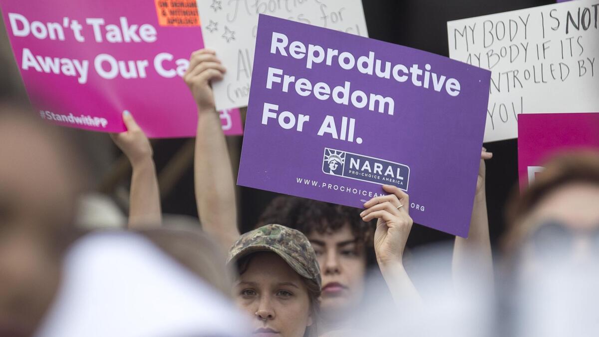 Protesters rally outside the Georgia statehouse May 7 after Gov. Brian Kemp signs the most restrictive anti-abortion law in the nation.