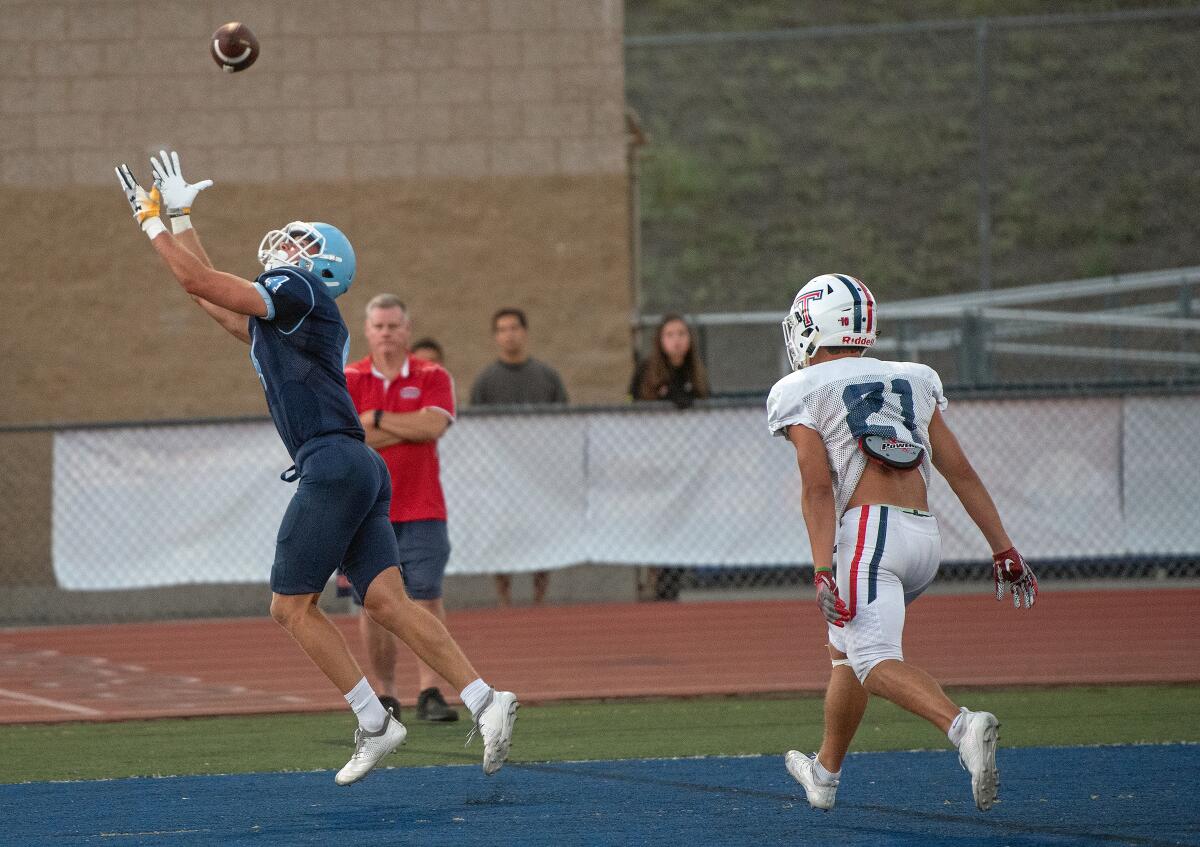 Corona del Mar wide receiver John Humphreys catches a touchdown pass in Friday’s scrimmage against Tesoro.