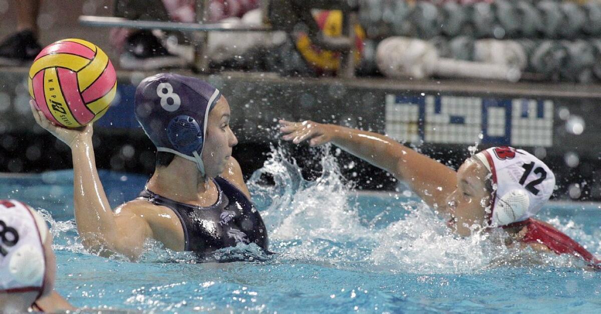 Crescenta Valley's Alexandra Garas shoots against Burroughs' Cameron Flores in the Pacific League girls' water polo championship at Burbank High on Thursday. Crescenta Valley won the game, 18-8.