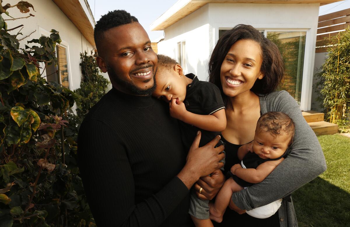 Michael Tubbs in a backyard photo with his wife and young children