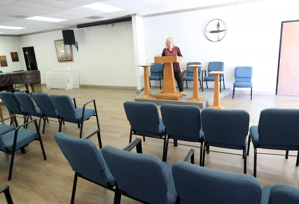 Rev. Sian Wiltshire, stands at her pulpit at the Orange Coast Unitarian Universalist Church in Costa Mesa. 