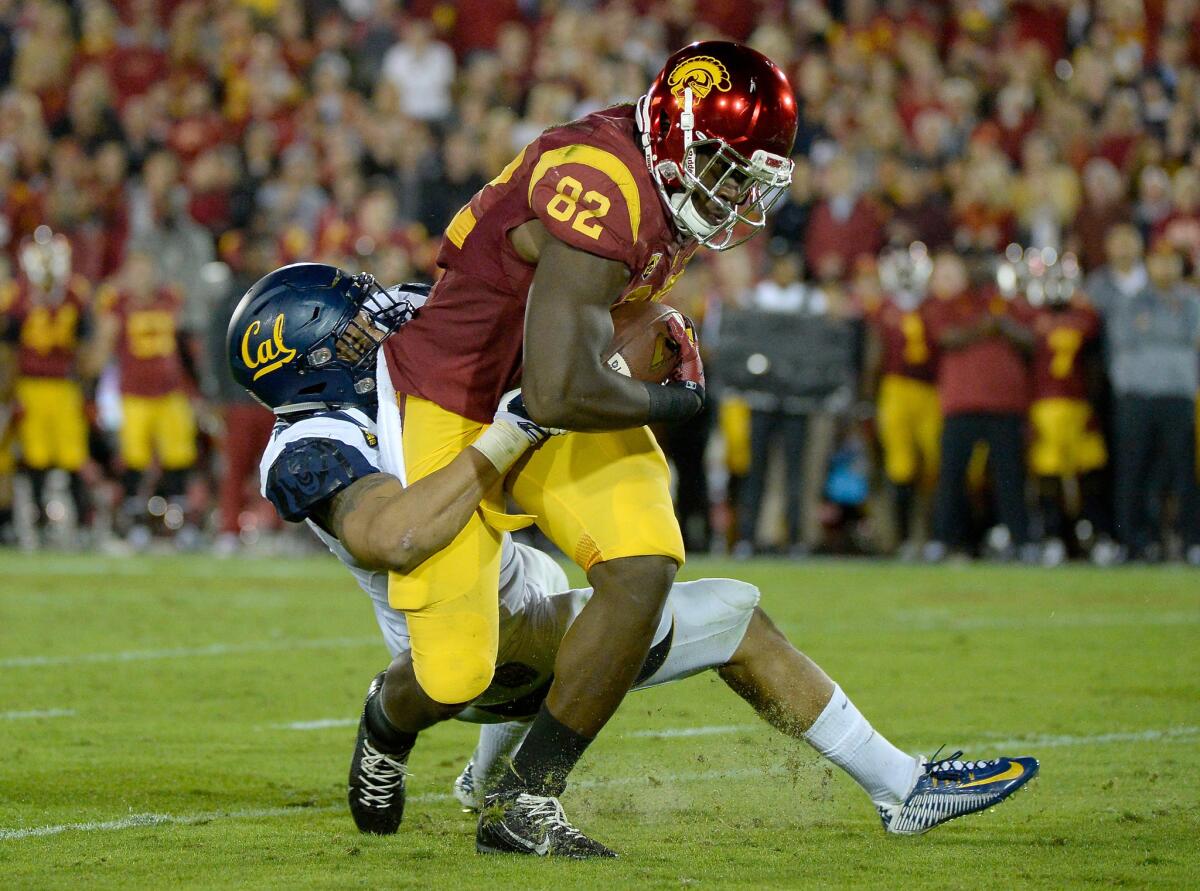 USC tight end Randall Telfer is tackled by California linebacker Michael Barton during a game last fall.