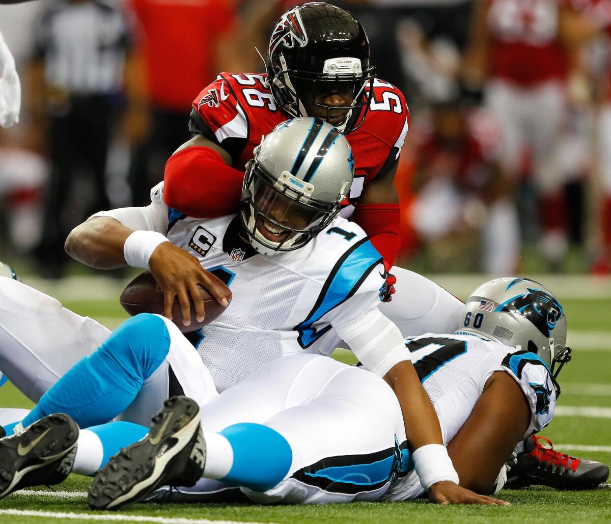 Panthers quarterback Cam Newton (1) is hit by Falcons linebacker Sean Weatherspoon (56) after pushing for a first down on Oct. 2.