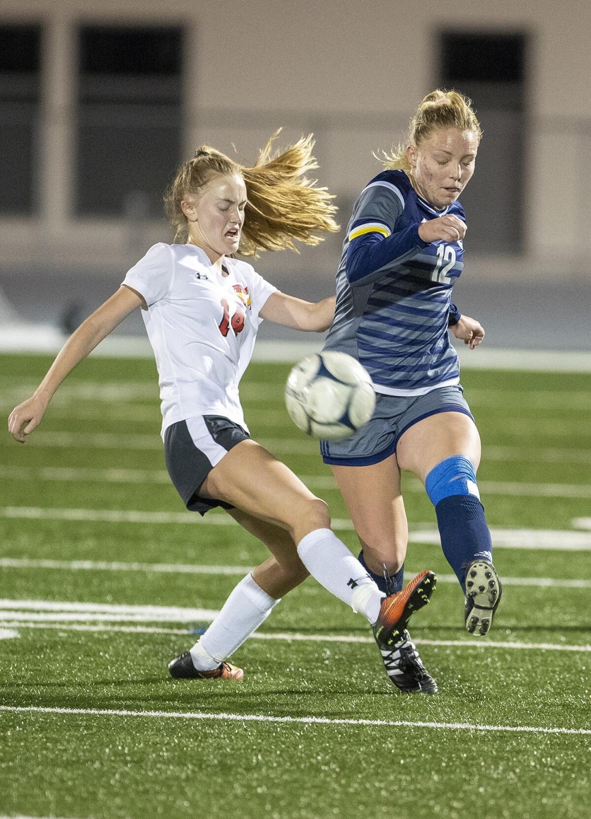 Newport Harbor's Emily Johnson, right, and Mission Viejo's Isabel McAteer battle for a ball in the first round of the CIF Southern Section Division 1 playoffs at Davidson Field on Feb. 6.