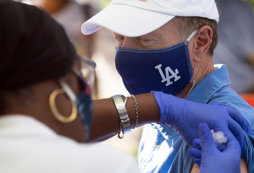 Nurse giving former LAUSD superintendent Austin Beutner a flu shot