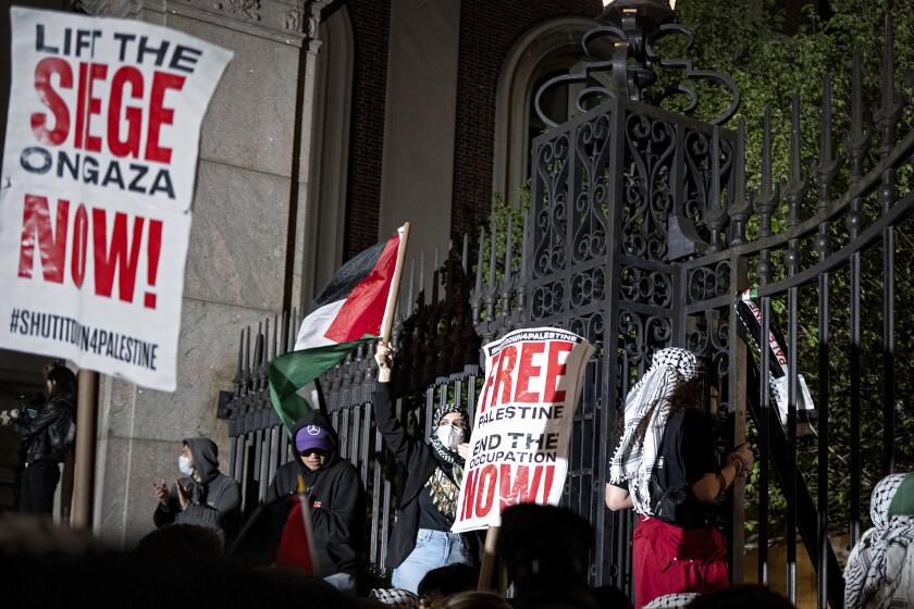 Pro-Palestianian protesters gather near a main gate at Columbia University in New York, Tuesday, April 30, 2024, just before New York City police officers cleared the area after a building was taken over by protesters earlier in the day. The building and a tent encampment were cleared during the operation. (AP Photo/Craig Ruttle)