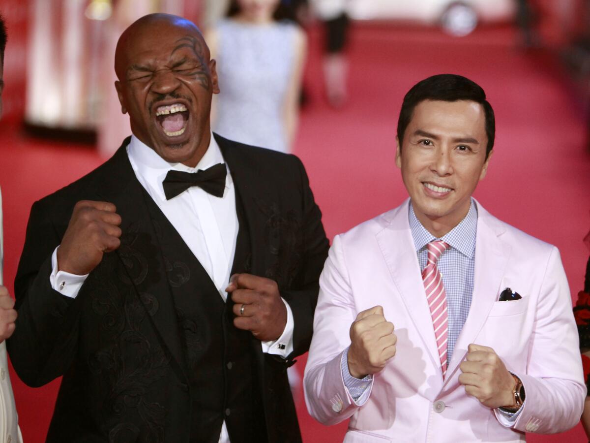 Mike Tyson, left, and Donnie Yen pose for a picture on the red carpet at the 18th Shanghai International Film Festival on June 13, 2015, in Shanghai.