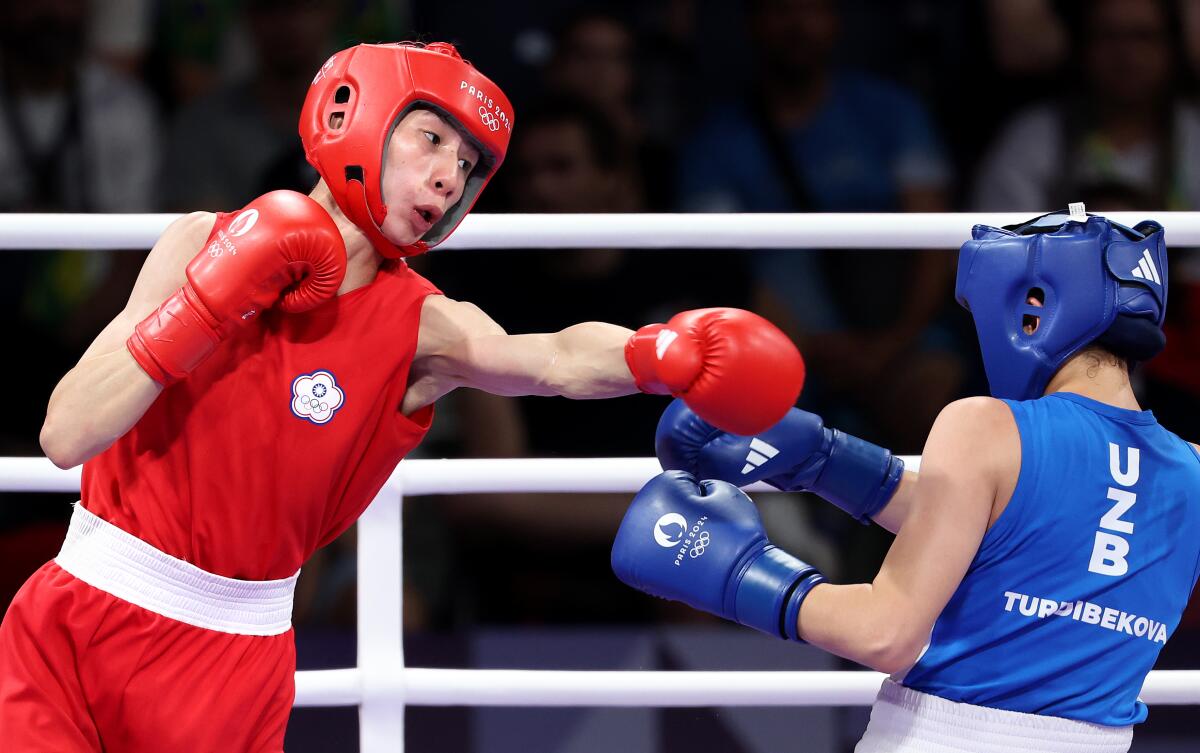 Taiwan's Lin Yu Ting, left, throws a punch at Uzebekistan's Sitora Turdibekova during an Olympic boxing match Friday.