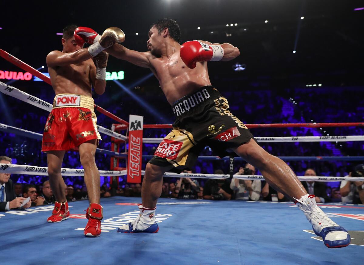 LAS VEGAS, NV - NOVEMBER 05: (R-L) Manny Pacquiao of the Philippines fires a right at opponent Jessie Vargas during their WBO welterweight championship fight at the Thomas & Mack Center on November 5, 2016 in Las Vegas, Nevada. (Photo by Christian Petersen/Getty Images) ** OUTS - ELSENT, FPG, CM - OUTS * NM, PH, VA if sourced by CT, LA or MoD **
