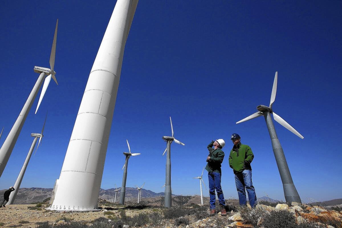 Kevin Martin, left, and Randy Hoyle of Terra-Gen Power inspect wind turbines at Alta East wind energy project in the Tehachapis last month.