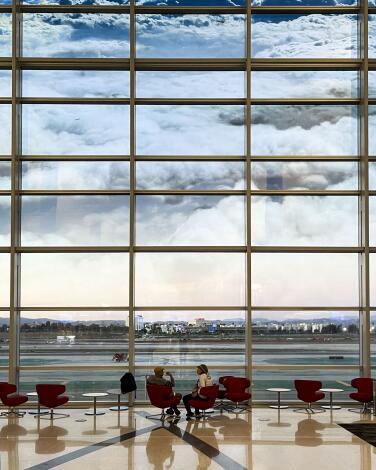 In the LAX Bradley International Terminal's West Gates concourse, artist Diana Thater has superimposed a dreamy cloud image over a large glass wall. The 2021 artwork is called "Cloud Wall."