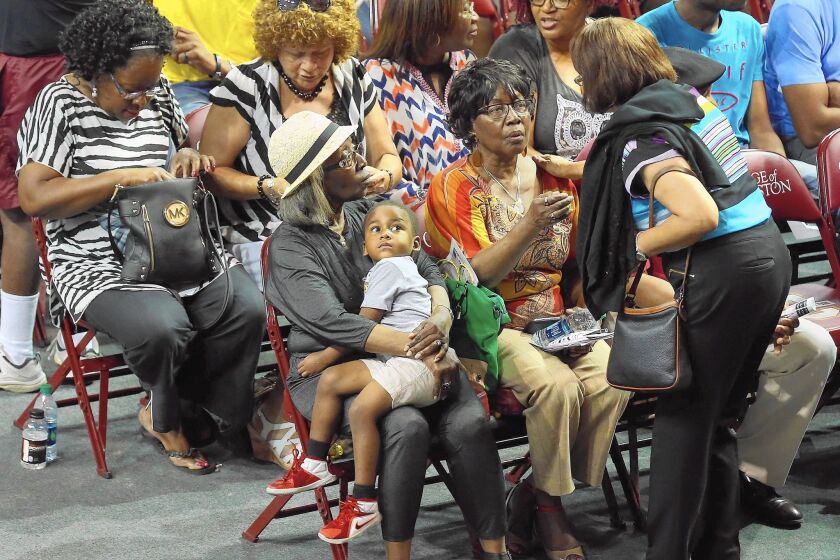 Family members of victims of Wednesday night’s mass shooting at Emanuel AME Church gather for a prayer vigil at an arena in Charleston, S.C.