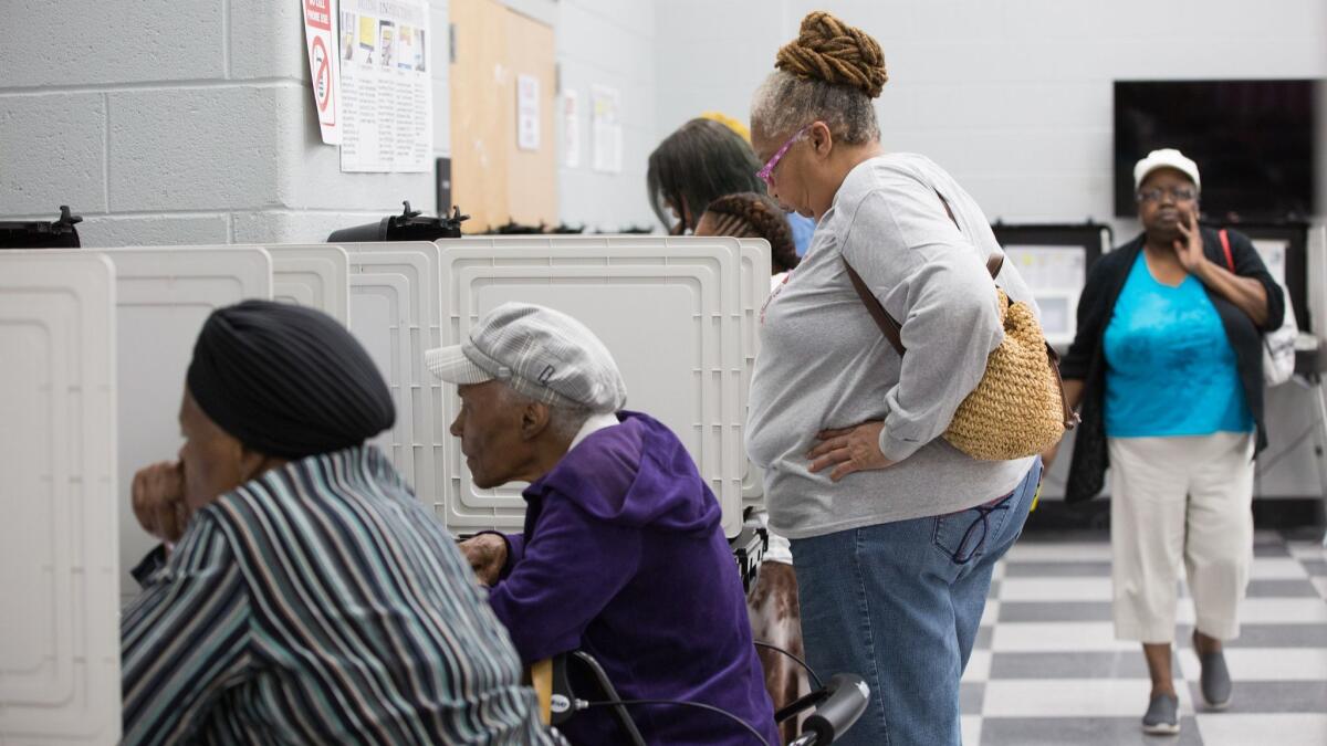 Voters cast ballots early in Atlanta. Georgia's gubernatorial election is a close race between Democrat Stacey Abrams and Republican Brian Kemp.