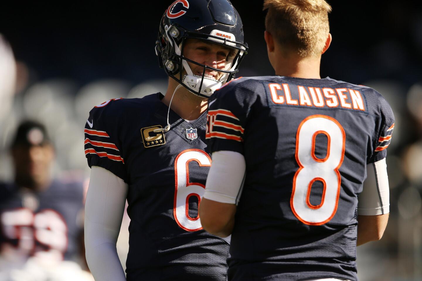 Jay Cutler talks with quarterback Jimmy Clausen before the game against the Vikings.