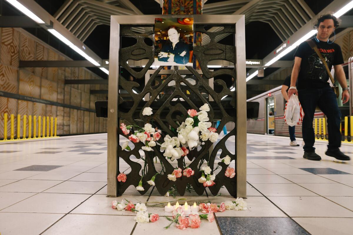 Flowers and photos are left at a column in a Metro station 