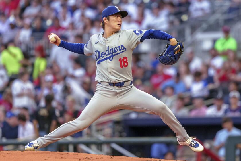 Los Angeles Dodgers pitcher Yoshinobu Yamamoto throws in the first inning of a baseball game.