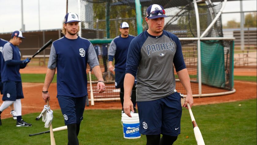 Travis Jankowski, left, and Hunter Renfroe walk off the field after batting during a spring training workout.