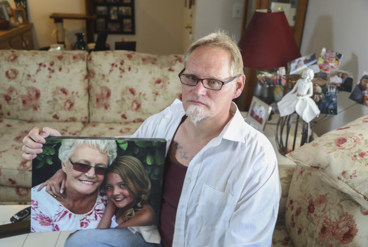Chuck Beckner with a picture of his mom and niece. Beckner’s mom, Billie Sue Matchke, died of COVID-19.
